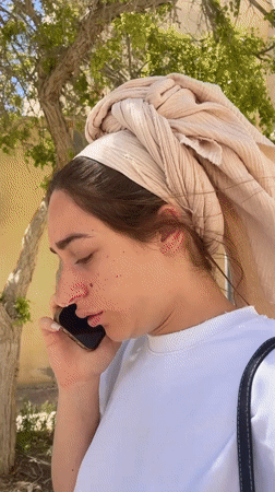 Woman makes phone call outdoors in Mitzpe Ramon