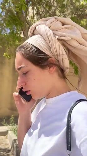 Woman makes phone call outdoors in Mitzpe Ramon