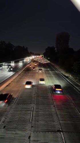 LA highway at night, light trails and steady traffic flow