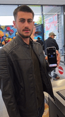 Man in leather jacket uses self-checkout in Essen