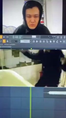 The video is split into three parts horizontally. The top part shows a man in a black hoodie looking down. The middle part shows a video sequence. The first scene in the sequence is a person wearing black clothing sitting in a bathtub with their back to the camera. Then it cuts to a scene that seems to be shot on a security camera showing a person in black clothing standing next to what appears to be a desk, then running off camera. The last scene shows a black bird sitting on a tree branch. The bottom part shows what appears to be a digital audio workstation interface, possibly for music production. The video includes an overlay of audio.