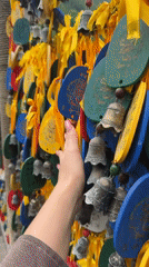 Tourist explores traditional water wheels and dragon sculptures in Jundiping