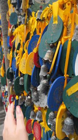 Tourist explores traditional water wheels and dragon sculptures in Jundiping