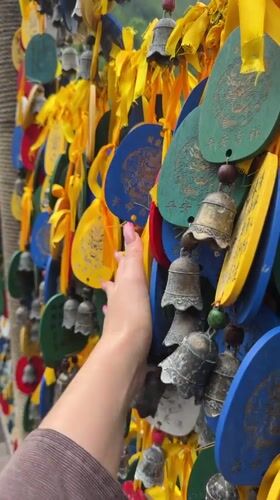 Tourist explores traditional water wheels and dragon sculptures in Jundiping