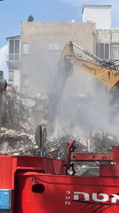 Building demolition underway in Tel Aviv with heavy machinery