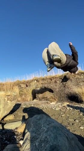 Beachcomber collects marine specimens along Ushuaia shore