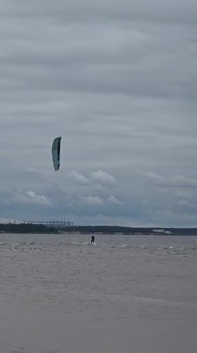 Kitesurfing and beach life in Sosnoviy Bor, nuclear plant backdrop