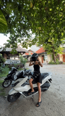 Woman spotted on white scooter in Kuta Selatan