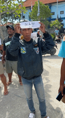 Tourist guides await arrivals at Indonesian harbor