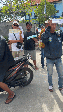 Tourist guides await arrivals at Indonesian harbor