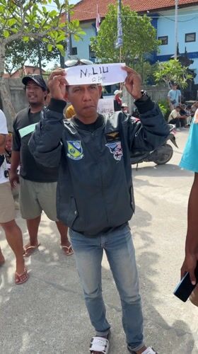 Tourist guides await arrivals at Indonesian harbor