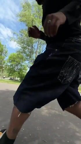 Man performs scooter tricks in sunny Lyon park