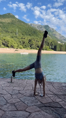 Woman does yoga workout on Montenegro waterfront jetty