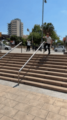 Scooter rider attempts stair rail trick in Barcelona