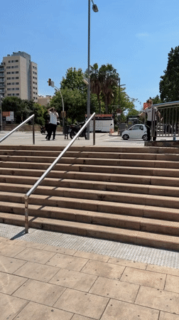 Scooter rider attempts stair rail trick in Barcelona