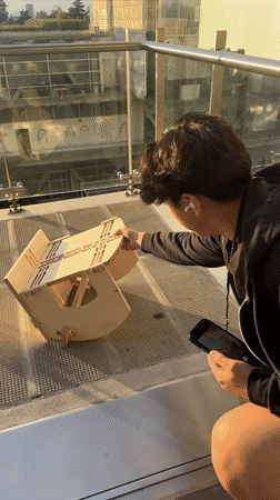 Mexico City residents document wooden craft assembly on balcony