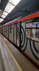 Moving through a Cyrillic-city subway on a July morning