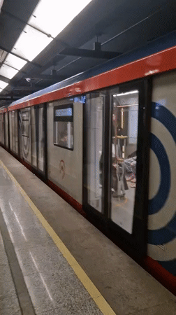 Moving through a Cyrillic-city subway on a July morning