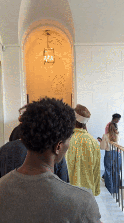 Inside a historic Milan building, people on the move