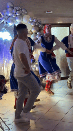 Folk dancers perform traditional Bulgarian line dance in Radomir