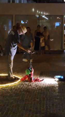 Nighttime puppet show draws a crowd in Quarteira's cobblestone plaza