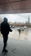 Morning commuters observed at wet Sofia train platform
