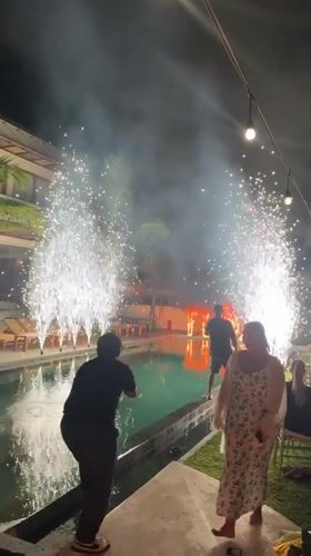 Fireworks illuminate poolside gathering in Kediri, Indonesia