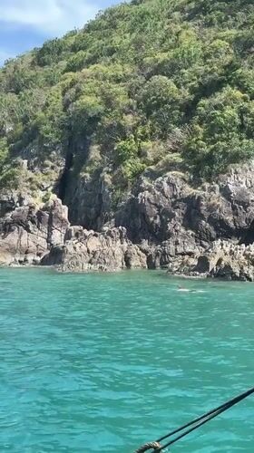 Swimmer spotted in turquoise waters near rocky Vietnam coastline