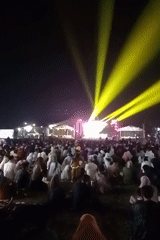 Nighttime community gathering with stage and crowds in Wonorejo