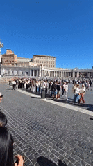 Morning crowds gather at St. Peter's Square under sunny skies