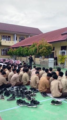 School cleanup day at a mosque courtyard, brooms and all