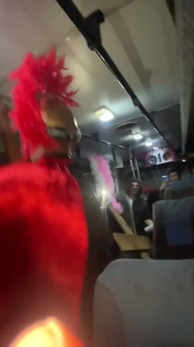 Costumed dancer performs in Roman outfit aboard Venezuela bus