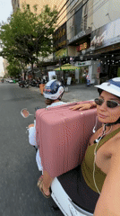 Two riders on white scooter in Da Nang