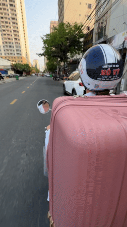 Two riders on white scooter in Da Nang