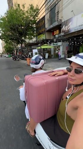 Two riders on white scooter in Da Nang