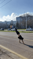 Street performer executes backflips, skateboard tricks near Varna monument