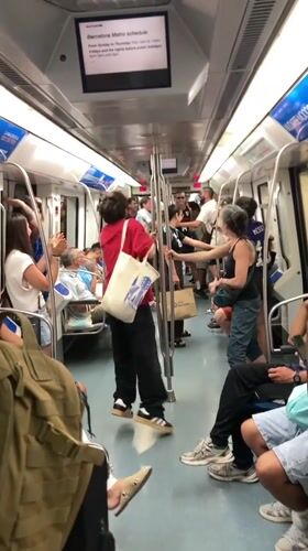 Impromptu dancing breaks out on a crowded Barcelona Metro car