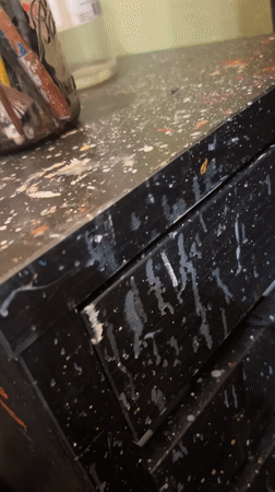 Artist documents workspace with paintbrushes and #WorkDiaries hashtag