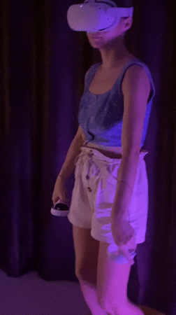 Woman uses VR headset in purple-lit room in Thailand