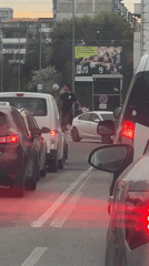 Unicyclist juggles soccer ball, bird amid Sofia traffic