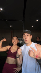Two people pose flexing at Mexican gymnasium