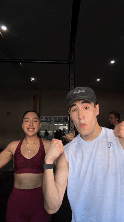 Two people pose flexing at Mexican gymnasium