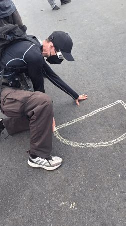 Protesters demonstrate outside Newark correctional facility with chalk art