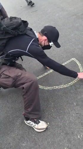 Protesters demonstrate outside Newark correctional facility with chalk art