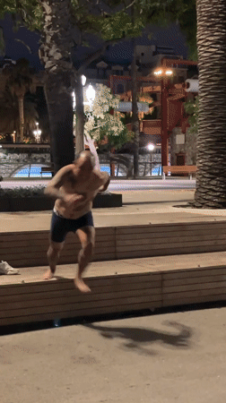 Man jumps into Barcelona harbor water at night