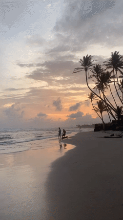 Stilt fishermen at work on Kathaluwa beach during sunset