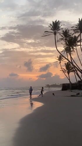 Stilt fishermen at work on Kathaluwa beach during sunset