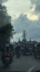 Slow traffic captured on Denpasar street, motorcycles and cars observed