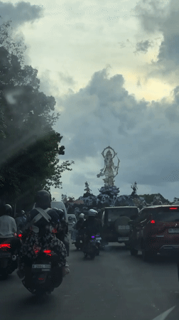 Slow traffic captured on Denpasar street, motorcycles and cars observed