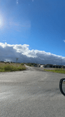Driving past greenhouses and buildings on a Russian road